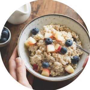 Bowl with a healthy breakfast and fruits and other foods.