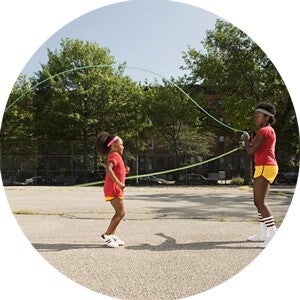A girl doing exercise by jumping rope.