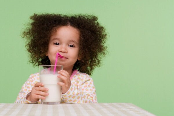 Milk powder next to a baby bottle.