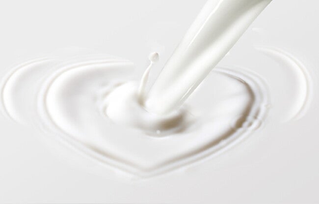 Milk to be poured into a heart shape.