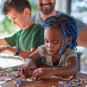 A girl puts together puzzles img